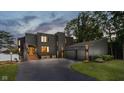 Modern home with dark exterior, attached two car garage, and well manicured lawn at 121 Wesley Cir, Noblesville, IN 46062