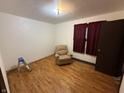 Bedroom with hardwood floors and an armchair, offering potential for a comfortable retreat at 1227 W 9Th St, Anderson, IN 46016