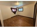 Cozy bedroom with hardwood floors and a bright window, creating a warm and inviting space at 1227 W 9Th St, Anderson, IN 46016