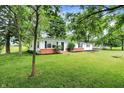 Charming single-story home with a green metal roof, fresh white paint, and a well-maintained lawn at 12471 N 100 E, Alexandria, IN 46001