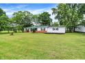 Charming single-story home with a green metal roof, fresh white paint, and a well-maintained lawn at 12471 N 100 E, Alexandria, IN 46001
