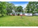 Charming single-story home with a green metal roof, fresh white paint, and a well-maintained lawn at 12471 N 100 E, Alexandria, IN 46001