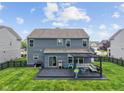 Backyard featuring dark wooden deck with pergola, ample seating and fenced in yard at 1306 Avocet Dr, Greenwood, IN 46143