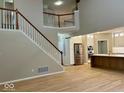 Elegant foyer with a staircase leading to an open floor plan and a modern kitchen at 13262 Landwood Dr, Fishers, IN 46037