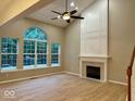 Bright living room with a vaulted ceiling, modern fireplace, and large windows at 13262 Landwood Dr, Fishers, IN 46037