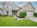 Beautiful brick home with a well-manicured lawn, attractive landscaping, and an attached garage at 16095 Tenor Way, Noblesville, IN 46060