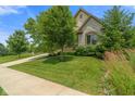 Beautiful home featuring stone and siding, professionally maintained lawn, and lush landscaping at 16548 Grand Cypress Dr, Noblesville, IN 46060