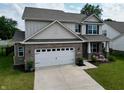 Beautiful two-story home with a brick and siding exterior, a two car garage, and well-manicured lawn at 16551 Branham Dr, Fishers, IN 46040