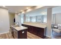 The kitchen is modern with a spacious counter and dark wood cabinetry, and an open layout to the dining room at 16551 Branham Dr, Fishers, IN 46040