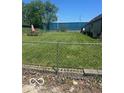 Large, enclosed backyard featuring green grass, patio furniture, and ample space at 2021 Columbia Ave, Indianapolis, IN 46202