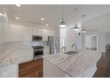 Modern kitchen featuring white cabinets, stainless steel appliances, and a marble-top island at 2078 Seneca Ln, Plainfield, IN 46168
