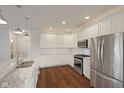 Well-lit kitchen with stainless steel appliances, marble counters, and hardwood flooring at 2078 Seneca Ln, Plainfield, IN 46168