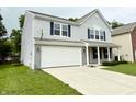 Side angle of home with two car garage, showing a well maintained lawn at 3314 Montgomery Dr, Indianapolis, IN 46227