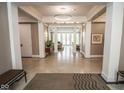 Expansive hallway with tile floors, architectural columns, and access to other community spaces at 355 E Ohio St # 211, Indianapolis, IN 46204