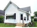 Charming white single Gathering home with a well-maintained lawn and an inviting front entrance at 408 W 4Th St, Anderson, IN 46016