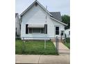 Charming white single Gathering home with a well-maintained lawn and an inviting front entrance at 408 W 4Th St, Anderson, IN 46016