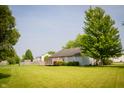 Spacious backyard with a large deck and lush greenery, perfect for outdoor activities at 4114 Dunedin Ct, Noblesville, IN 46062