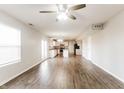 Open-concept living room showcasing hardwood floors and a modern kitchen at 413 Youngs Creek Ct, Franklin, IN 46131