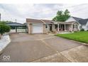 Wide driveway leading to a one-car garage and covered carport at 524 W Campbell St, Edinburgh, IN 46124