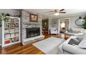 Inviting living room with hardwood floors, a brick fireplace, and a cozy reading nook with a built-in bookcase at 544 Everling Dr, Morgantown, IN 46160