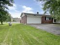 View of home's front, showcasing a lush lawn and a paved driveway leading to the garage at 5667 Broyles Rd, Avon, IN 46123