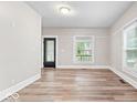 Bright living room features hardwood floors, neutral walls, and plenty of natural light from multiple windows at 57 E South St, Mooresville, IN 46158