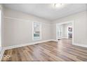 Spacious living room featuring hardwood floors, neutral walls, and an open doorway to the kitchen at 57 E South St, Mooresville, IN 46158