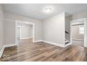 Open concept living room featuring hardwood floors, neutral walls, and open doorways to other rooms at 57 E South St, Mooresville, IN 46158
