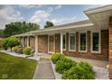 Close up of the front porch showing brick exterior and manicured landscaping at 5749 Teresa Dr, Alexandria, IN 46001