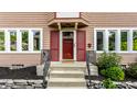 Close-up view of the front door with red shutters, complemented by landscaping at 5760 Central N Ave, Indianapolis, IN 46220