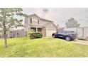 Charming two-story home featuring brick accents, a well-manicured lawn, and a convenient attached garage at 5924 Sable Dr, Indianapolis, IN 46221