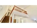 Hallway landing with staircase, wooden banister, and natural light, creating a warm and inviting atmosphere at 5924 Sable Dr, Indianapolis, IN 46221
