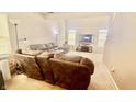 Cozy living room with neutral carpet, comfortable sofas, and ample natural light from windows, ideal for relaxing at 5924 Sable Dr, Indianapolis, IN 46221