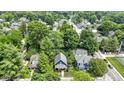 Birds eye view of neighborhood highlighting the home's location surrounded by mature trees at 6107 Broadway St, Indianapolis, IN 46220