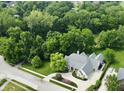 An aerial view displays the home's location amongst lush greenery and manicured landscaping at 7106 Royal Oakland Dr, Indianapolis, IN 46236