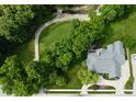 Aerial view of property showcasing golf course, mature trees, and a circular driveway at 7106 Royal Oakland Dr, Indianapolis, IN 46236