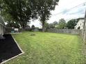 This backyard features a fire pit and a storage shed, and is enclosed by a wood fence at 729 Maple Ln, Brownsburg, IN 46112