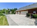 Three-car garage with ample parking space and a convenient basketball hoop at 7413 Misty Woods Ln, Indianapolis, IN 46237
