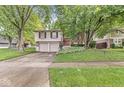 Charming two-story home featuring brick and siding, complemented by a well-manicured lawn and inviting curb appeal at 7616 E Concord Ln, Fishers, IN 46038
