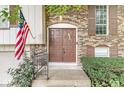 Close-up of the front entrance, highlighting the brickwork, the double-door entry and an American flag at 7616 E Concord Ln, Fishers, IN 46038