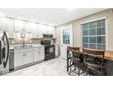 This kitchen features modern appliances, bright cabinets, and an island at 7616 Concord Ln, Fishers, IN 46038