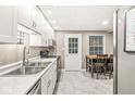 This kitchen features modern appliances, bright cabinets, and a breakfast bar at 7616 Concord Ln, Fishers, IN 46038