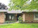 Attractive brick home featuring a cozy covered porch at 7721 Hollybrook Ln, Indianapolis, IN 46227