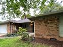Classic brick ranch home with manicured front lawn and a covered porch at 7721 Hollybrook Ln, Indianapolis, IN 46227