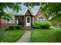Charming brick house with well-manicured lawn and a welcoming front porch at 828 N Butler Ave, Indianapolis, IN 46219