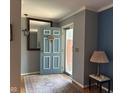 Inviting entryway featuring a blue front door, stylish decor, and hardwood floors with a rug at 9011 Camby Rd, Camby, IN 46113