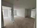Unfinished room featuring white walls and trim, a door leading to another room and a view of the neighborhood at 9137 Steinbeck Ln, Indianapolis, IN 46239