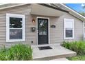 Close-up of the home's front door, complemented by bright windows and neat landscaping for a welcoming appeal at 917 W Pearl St, Lebanon, IN 46052
