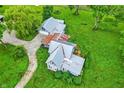 Aerial view of a charming home, showcasing its unique roofline and surrounding lush greenery, including a weeping willow at 9237 N 500 W, Fountaintown, IN 46130