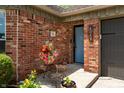 Charming brick entryway with a colorful flower arrangement on an ornate stand at 9520 Settlement W Dr, Indianapolis, IN 46250
